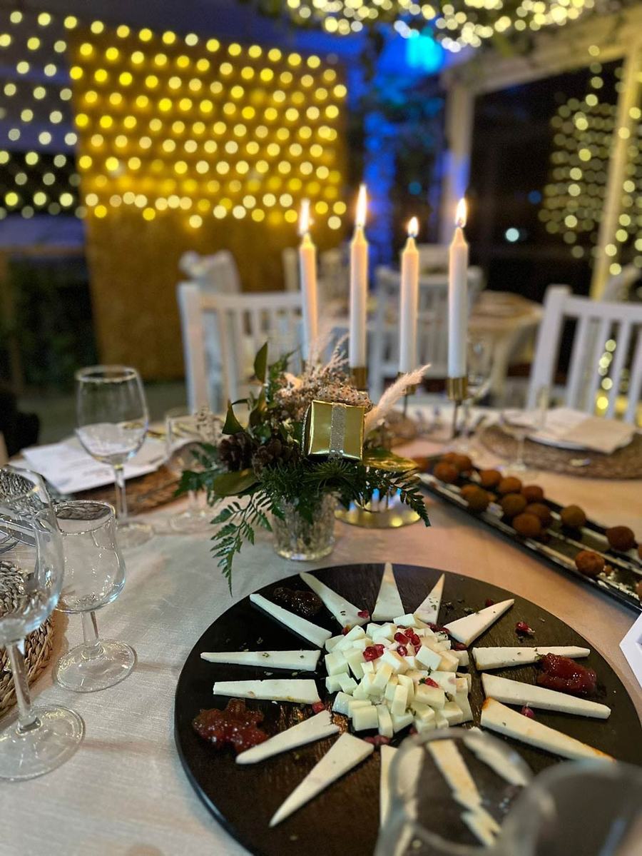 Mesa con velas y tabla de quesos para una cena privada